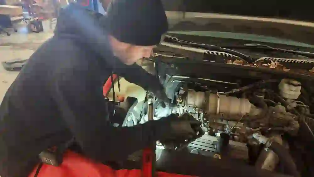 Mechanic replacing the steering rack and fixing a coolant leak on a Buick Lucerne