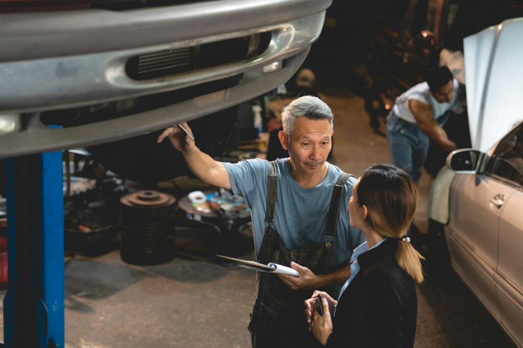 customer making inspection check to a car engine repair occupation job at garage service