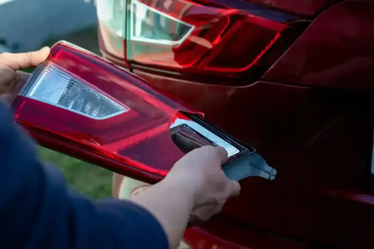 Hands of a man repairing a car. Repair work. Mechanic. Car headlight. New and broken car headlights