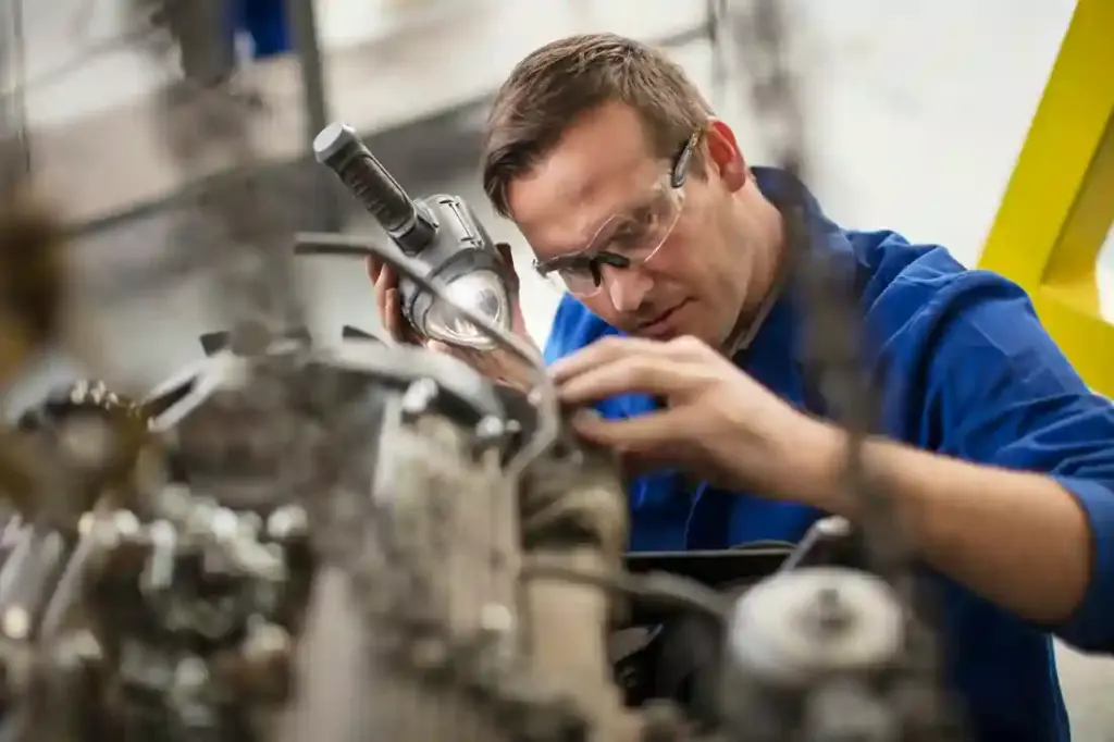 Mechanic concentrating on engine repairs.