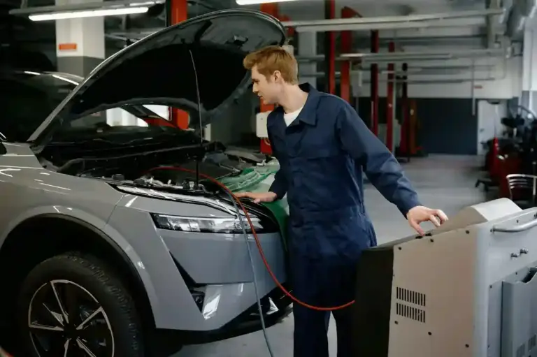 mechanic at broken arrow auto repair shop doing a  air conditioner leak detection