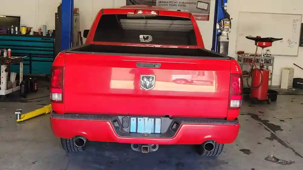 Rear view of a red Dodge Ram 1500 inside T Autocare Takedown’s auto shop in Broken Arrow for a pre-purchase vehicle inspection.